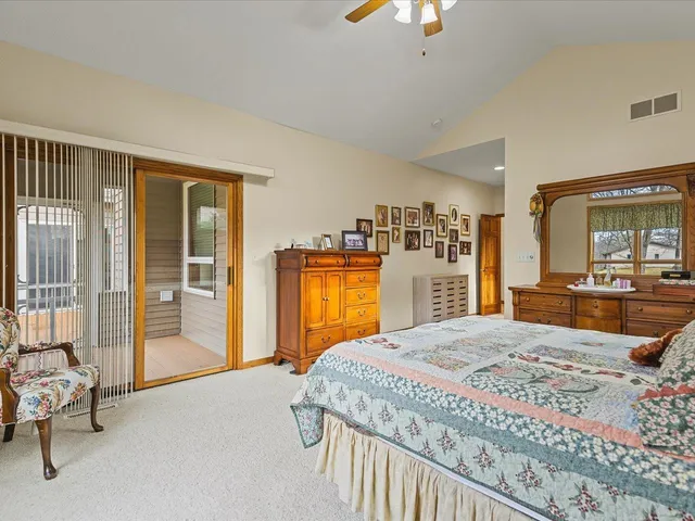 a bedroom with a large bed and a chandelier