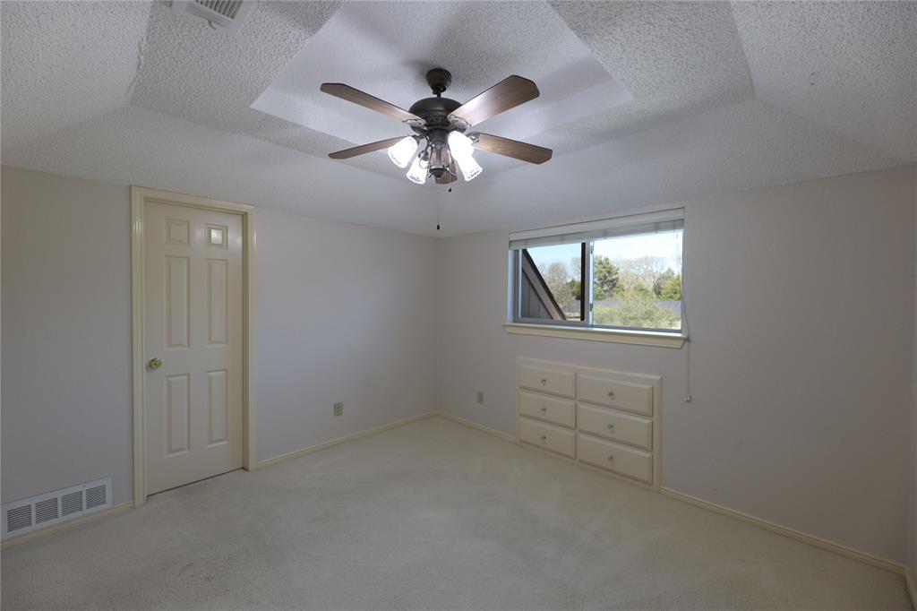 907 Red Oak Creek Road Ovilla, TX 75154 - Photo 17 of 20 an empty room with windows and fan