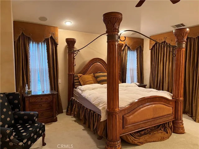 a bedroom with a bed window and dresser