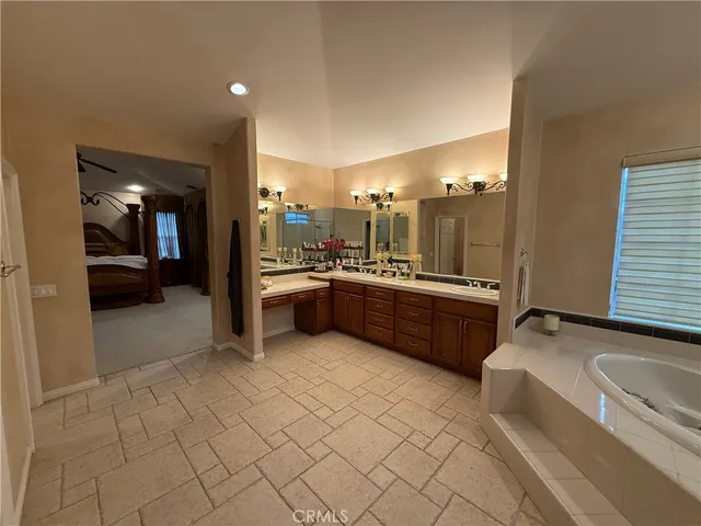 a large bathroom with a large tub and double vanity