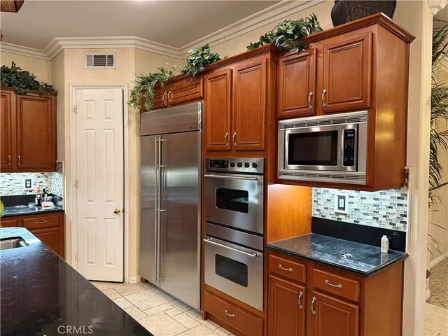 a kitchen with granite countertop a refrigerator stove and washer
