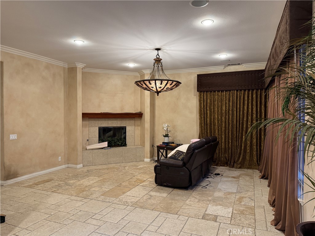 2119 Ridgeview Terrace Drive Signal Hill, CA 90755 - Photo 8 of 22 a living room with furniture a chandelier and a fireplace