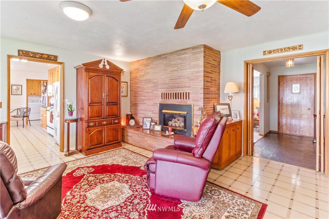 1710 Southwest Gails Avenue Chehalis, WA 98532 - Photo 7 of 24 a living room with furniture a rug and a fireplace