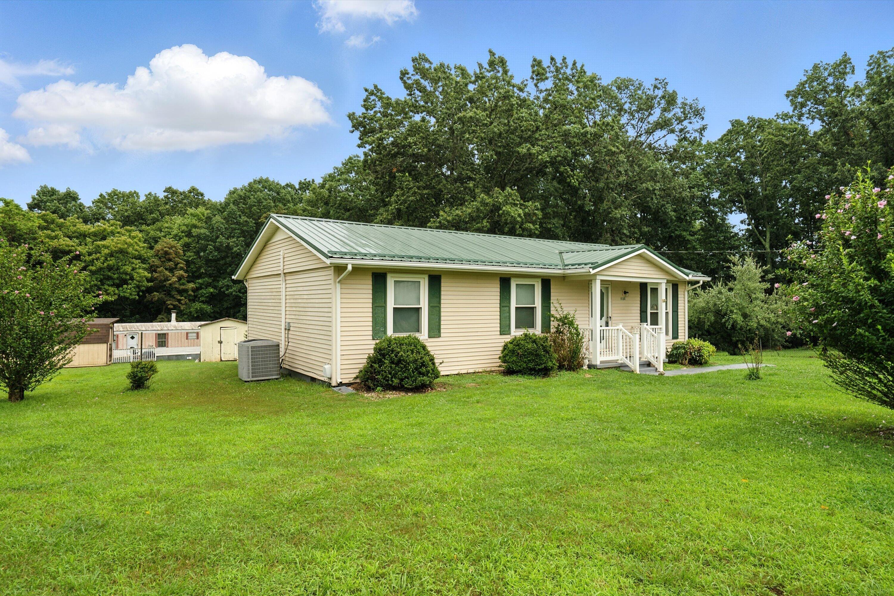a view of a house with a yard and deck