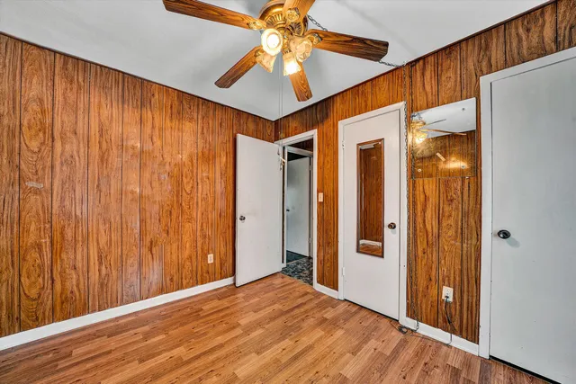 a view of a bedroom with a chandelier fan and a closet