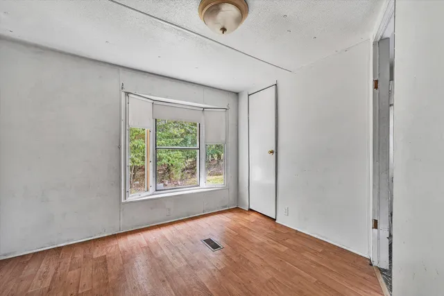 a view of a porch with wooden floor and furniture