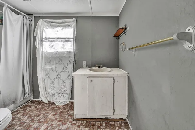 a kitchen with stainless steel appliances granite countertop a stove top oven a refrigerator and a cabinets with wooden floor