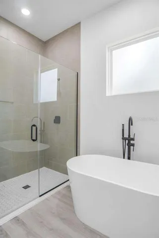 a bathroom with a bathtub and shower