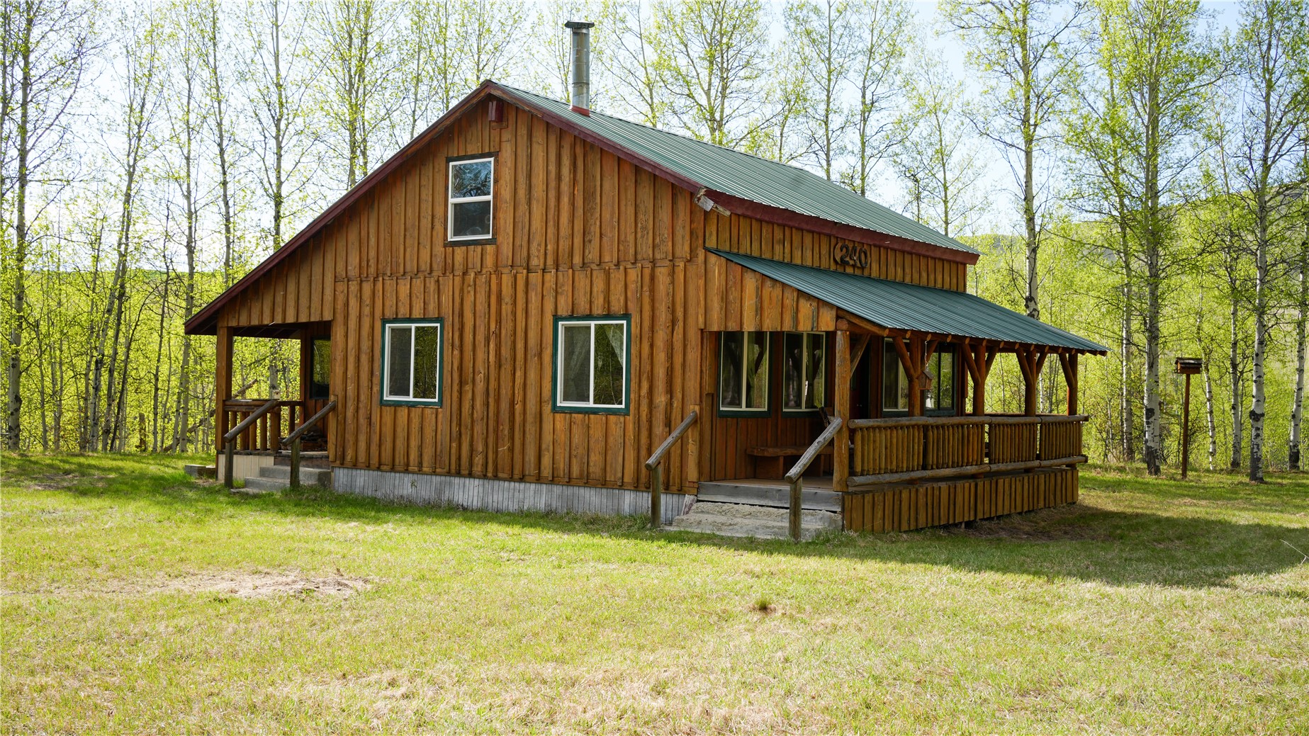 240 Old Railroad Road Oroville, WA 98844 - Photo 2 of 24 a front view of a house with a yard