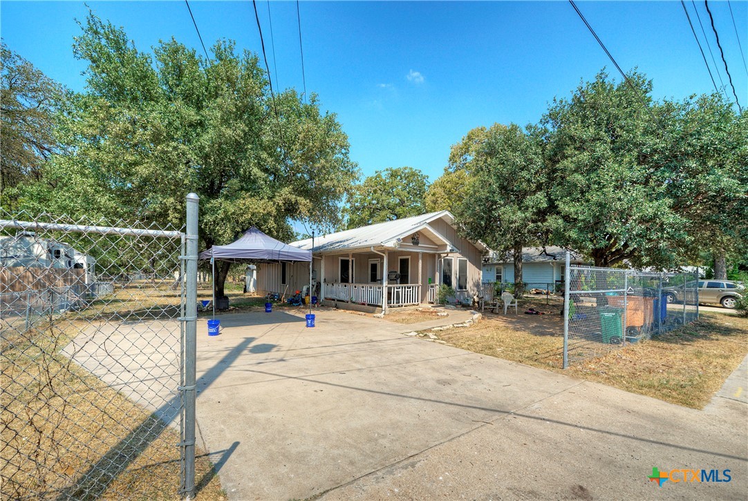 a view of a house with backyard patio and swimming pool