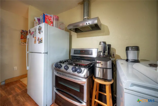 a kitchen with a stove and a refrigerator