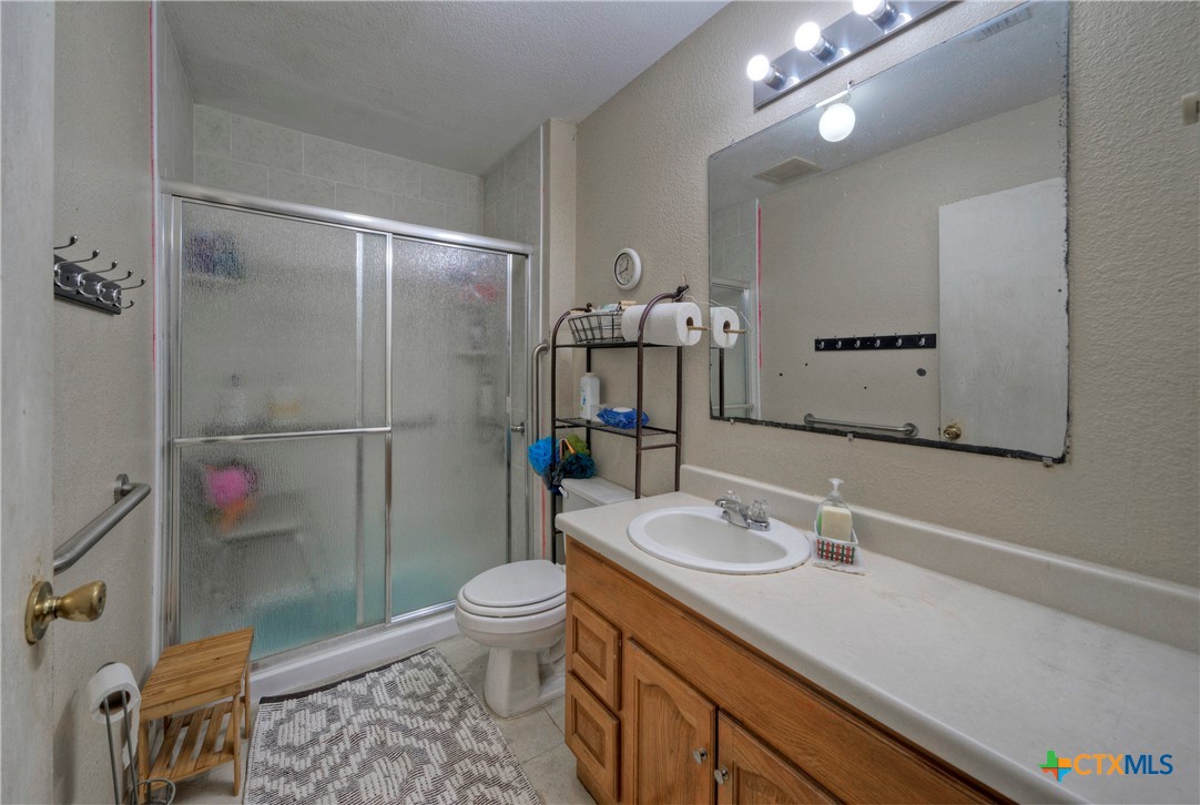 604 Vargas Road Austin, TX 78741 - Photo 23 of 25 a bathroom with a sink a toilet and shower