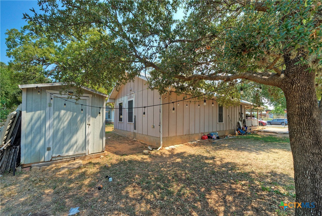 604 Vargas Road Austin, TX 78741 - Photo 5 of 25 a view of a backyard with large tree and wooden fence
