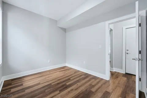 a view of room with wooden floor