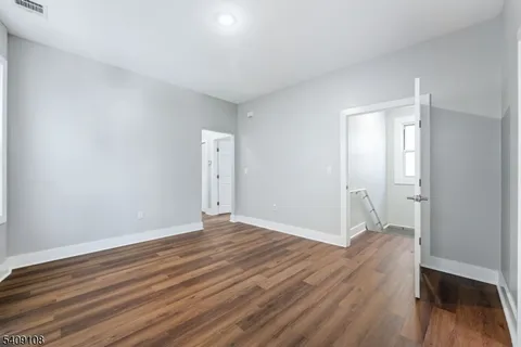 a view of a room with wooden floor