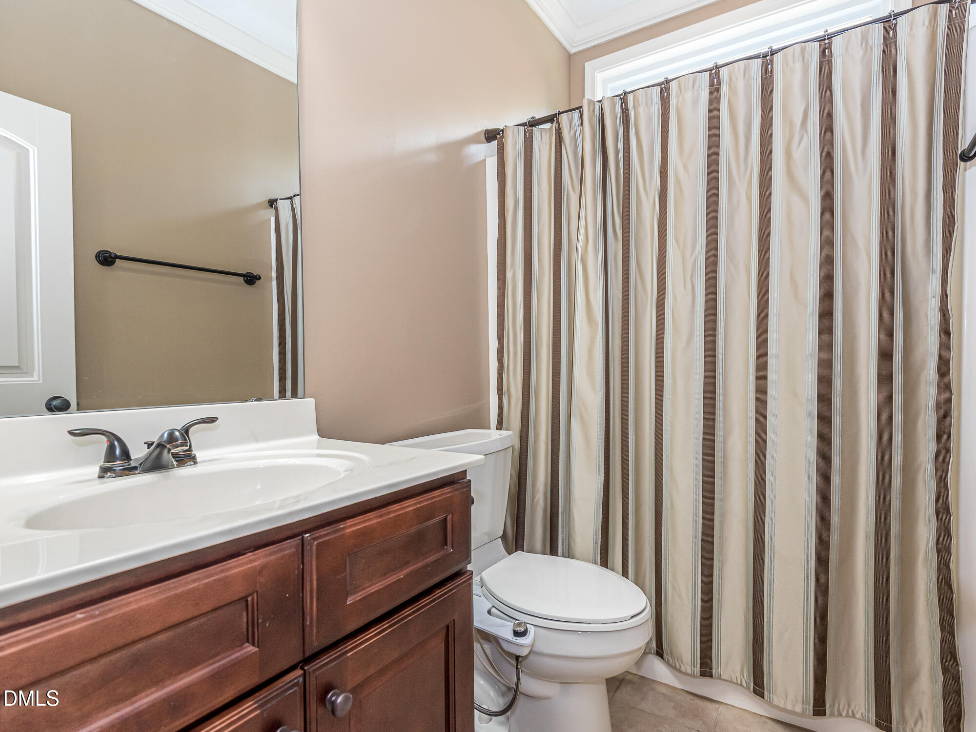 337 Shadowdale Lane Rolesville, NC 27571 - Photo 29 of 42 a bathroom with a sink a toilet a mirror and shower curtain