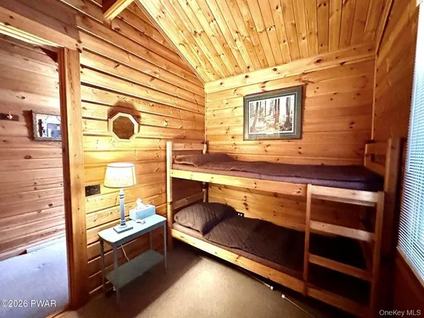 a view of walk in closet and wooden floor