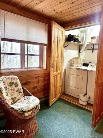 a living room with furniture and a clock