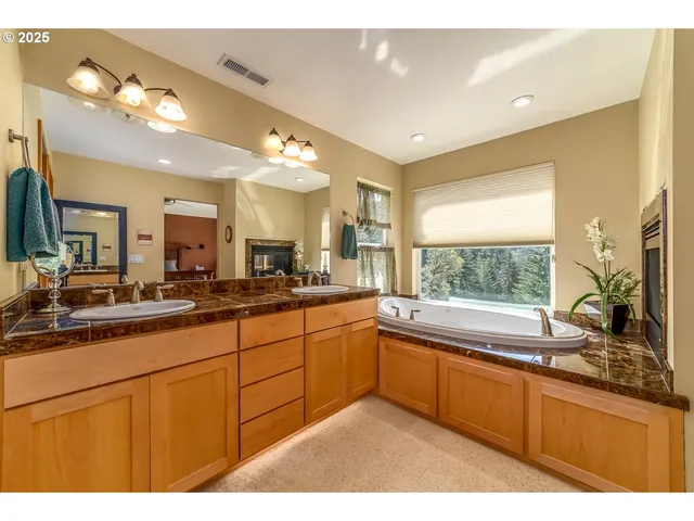 a large bathroom with a large tub and sink