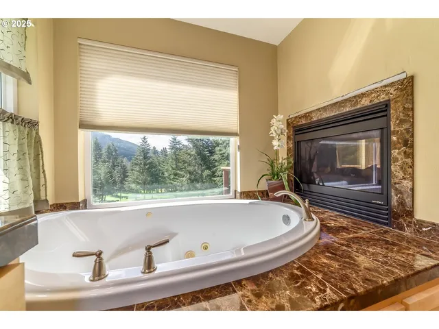a bath tub sitting in a room next to a window
