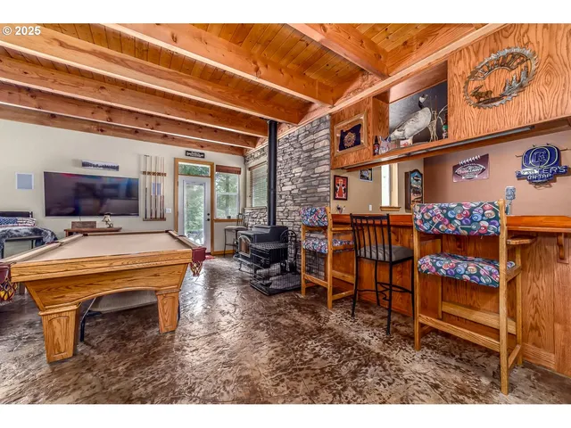 a living room with furniture a fireplace and a table