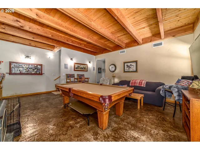 a living room with furniture a rug and a projector