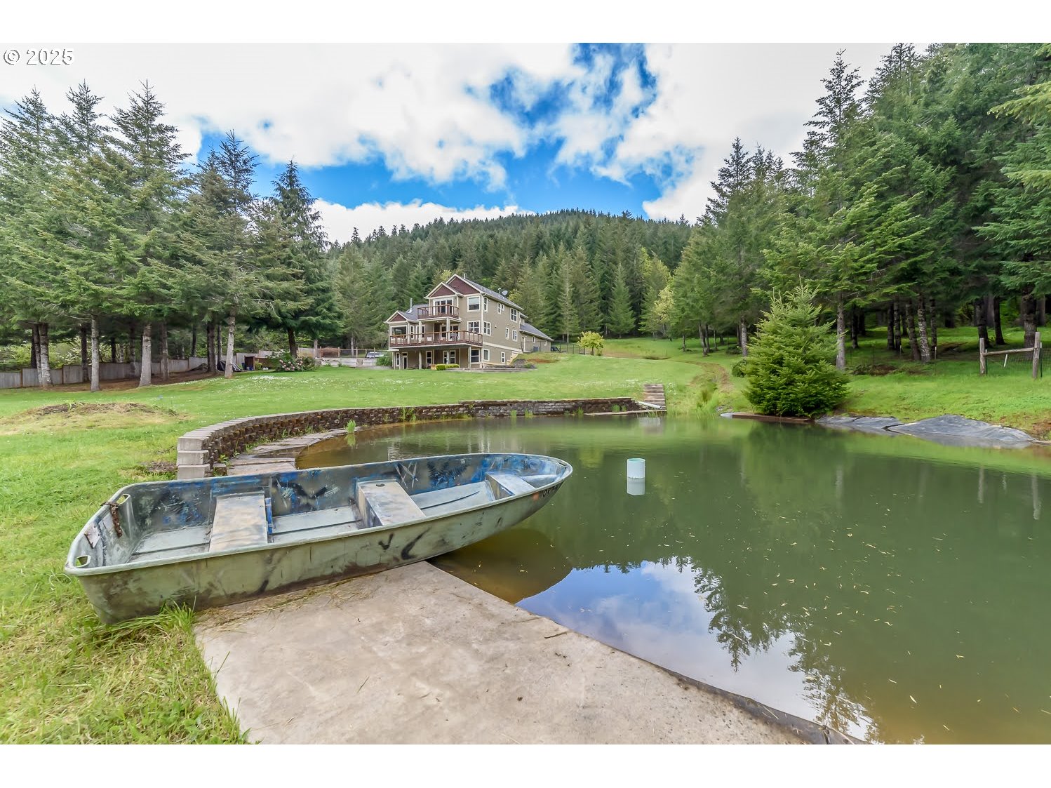 21626 Glaze Road Noti, OR 97461 - Photo 32 of 43 a view of a lake with a yard and a large tree