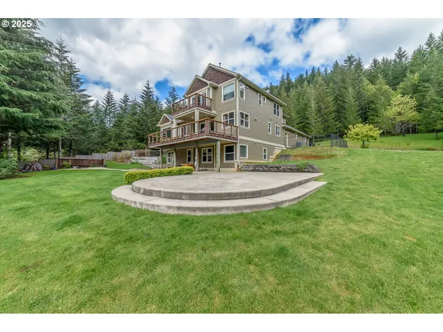 a view of a house with a big yard and a fountain