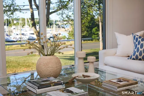 a living room with furniture and a floor to ceiling window