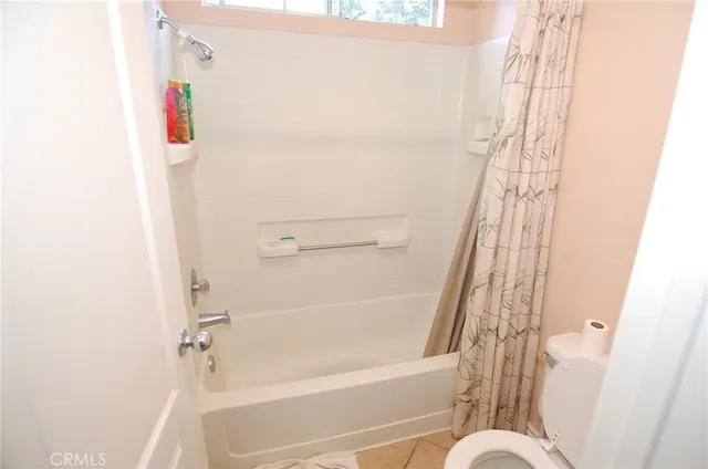 a bathroom with a bathtub and shower