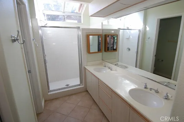 a bathroom with a double vanity sink and mirror