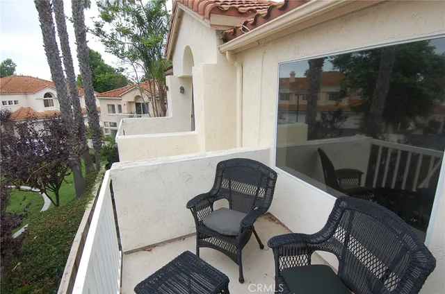 a view of a patio with table and chairs and potted plants