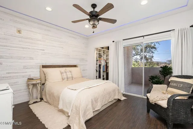 a bedroom with a bed and a large window