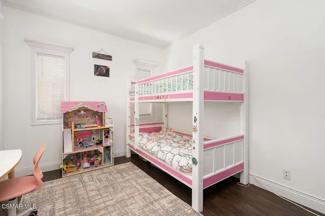 a bed room with a bed and a chair