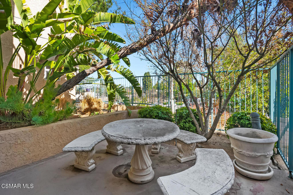 2716 Borchard Road Newbury Park, CA 91320 - Photo 27 of 30 a view of a patio with table and chairs potted plants and large tree
