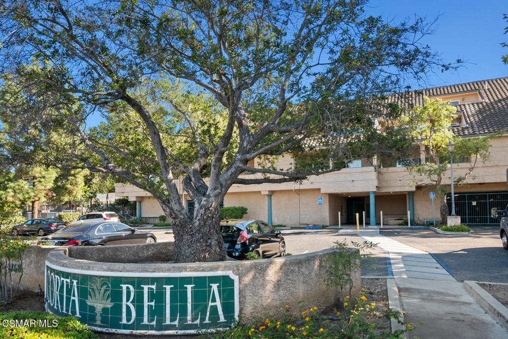 2716 Borchard Road Newbury Park, CA 91320 - Photo 30 of 30 a view of a white house with a large tree and flower plants