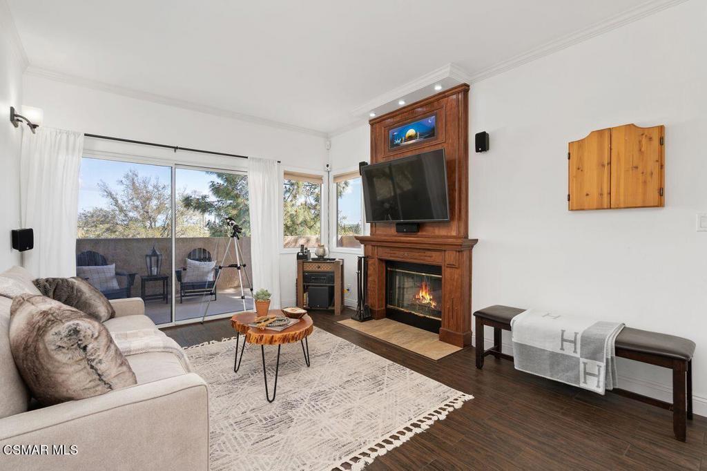 2716 Borchard Road Newbury Park, CA 91320 - Photo 4 of 30 a living room with furniture a flat screen tv and a fireplace