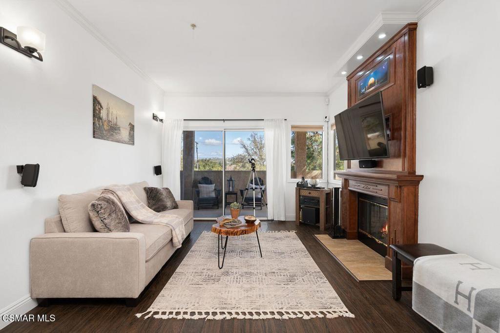 2716 Borchard Road Newbury Park, CA 91320 - Photo 5 of 30 a living room with furniture a rug a flat screen tv and a refrigerator