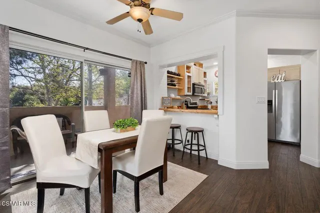 a dining room with furniture a chandelier and wooden floor