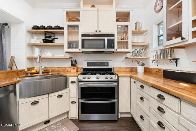 a kitchen with stainless steel appliances granite countertop a stove and a sink