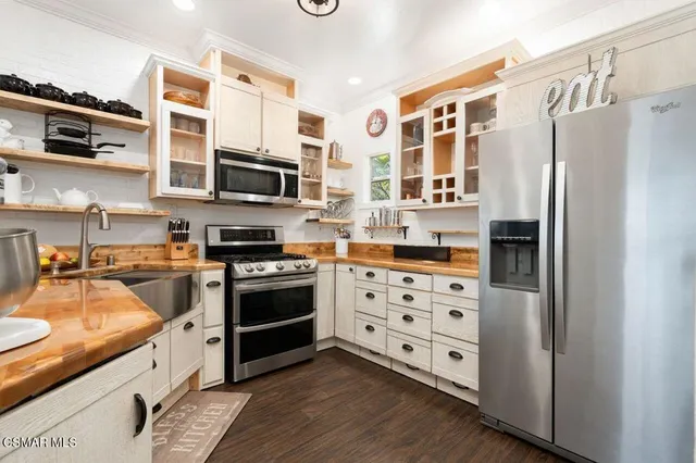 a kitchen with stainless steel appliances and wooden cabinets