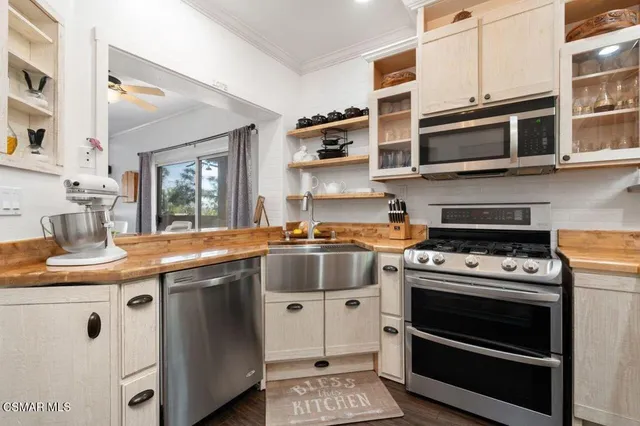 a kitchen with stainless steel appliances granite countertop a stove and a microwave