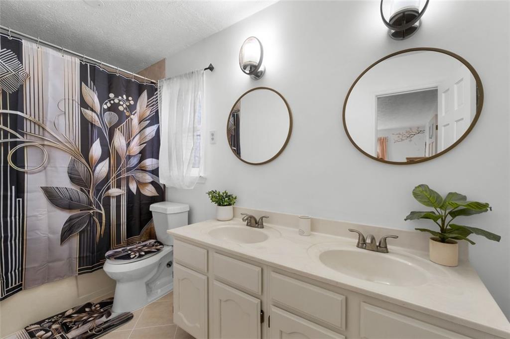 58 Cedar Bluff Winder, GA 30680 - Photo 11 of 39 a bathroom with a toilet sink and mirror