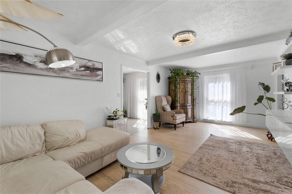 58 Cedar Bluff Winder, GA 30680 - Photo 22 of 39 a living room with furniture a rug and a chandelier
