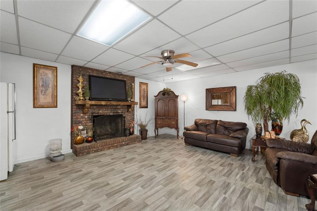 58 Cedar Bluff Winder, GA 30680 - Photo 25 of 39 a living room with furniture a fireplace and a flat screen tv