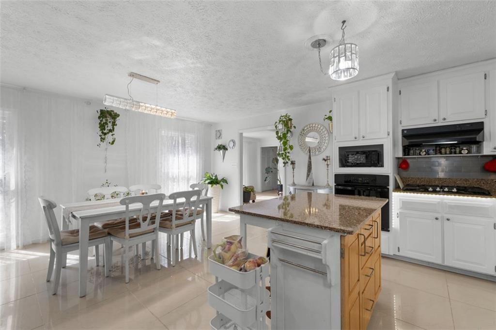 58 Cedar Bluff Winder, GA 30680 - Photo 31 of 39 a kitchen with kitchen island granite countertop a sink and center island