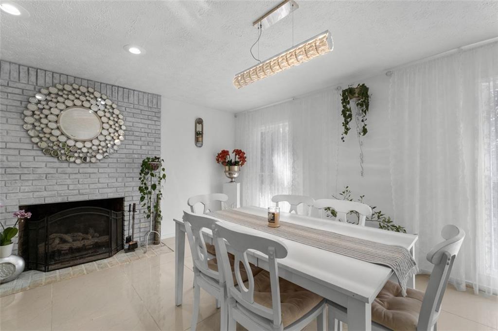 58 Cedar Bluff Winder, GA 30680 - Photo 8 of 39 a dining room with furniture and a fireplace