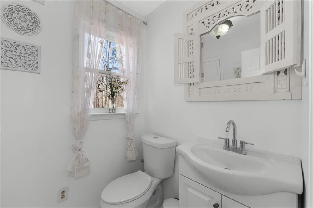 58 Cedar Bluff Winder, GA 30680 - Photo 9 of 39 a bathroom with a toilet sink and mirror