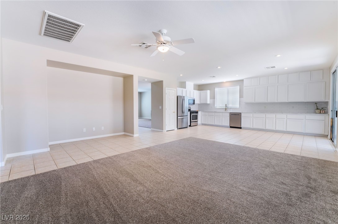 7857 Midnight Ride Street Las Vegas, NV 89131 - Photo 11 of 53 Living room featuring light tile and brand new carpet
