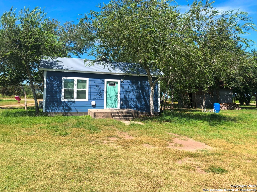 443 Bee Tuleta, TX 78142 - Photo 2 of 27 a view of a house with a yard patio and a garden